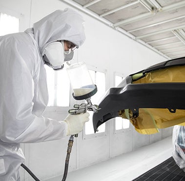 Collision Center Technician Painting a Vehicle | Orem Toyota ES in Orem UT