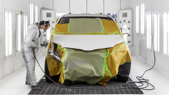 Collision Center Technician Painting a Vehicle | Orem Toyota ES in Orem UT